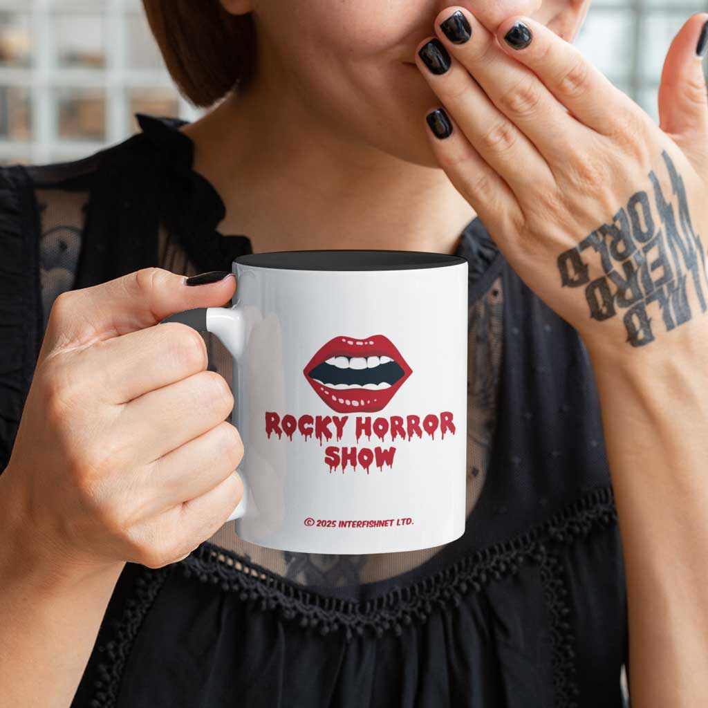 A young woman laughing and drinking from an official Rocky Horror Show mug